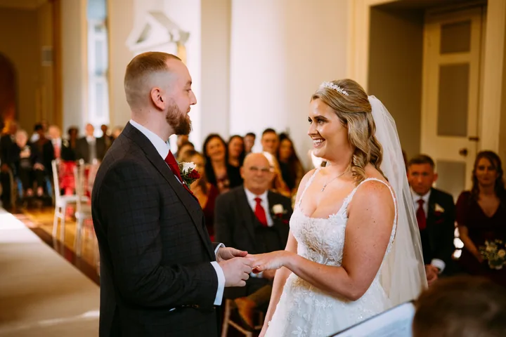 Rebecca and Sean during their wedding ceremony at Clearwell Castle, with bridal hair by Hair Up Solutions