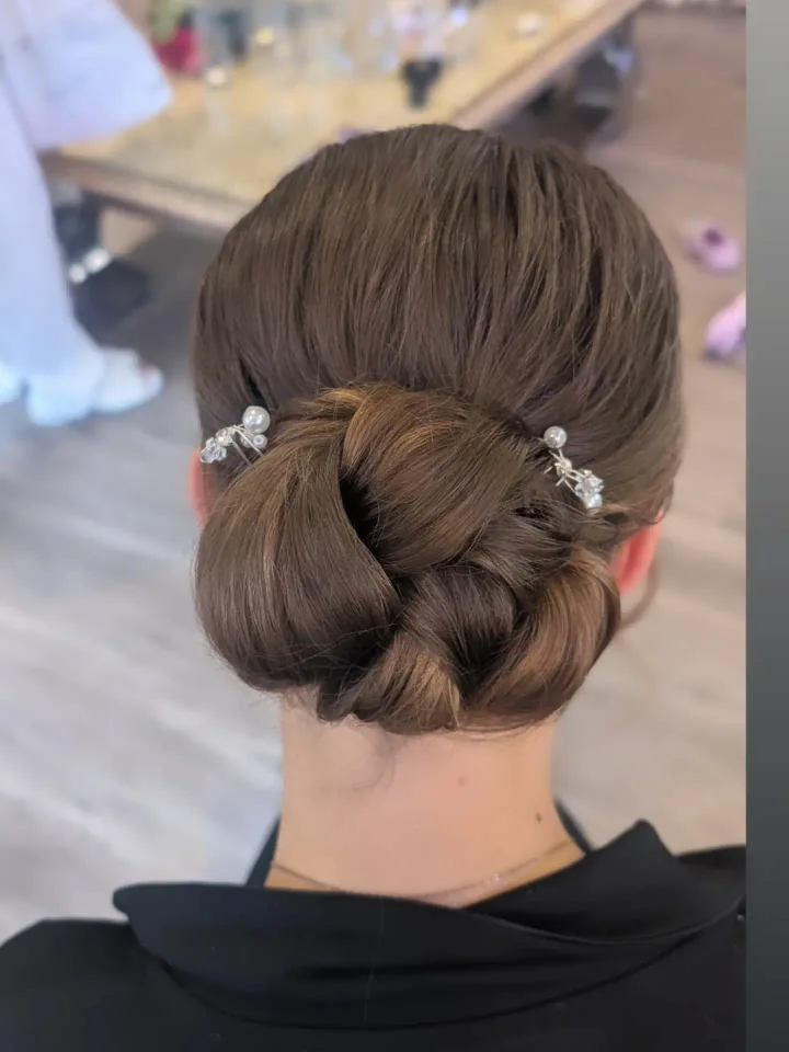 A polished brunette bridal bun from Becky’s portfolio.