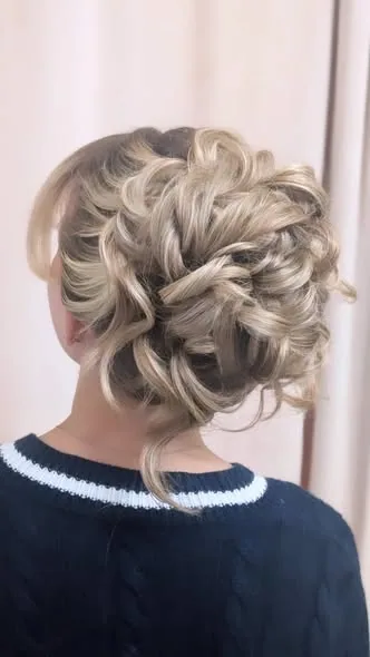 A textured blonde updo with woven sections, photographed from behind in Becky’s portfolio.